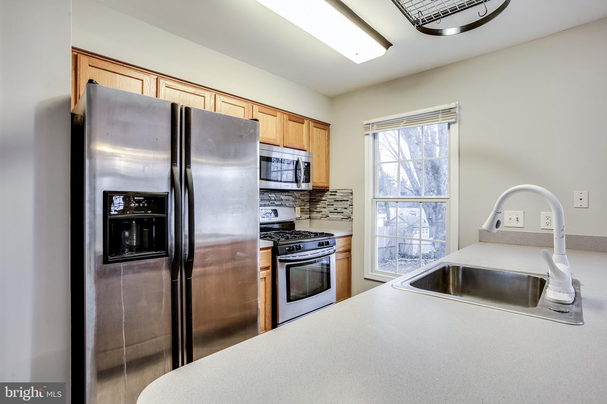 11506 Joseph Mill Road Silver Spring, MD 20906 - Photo 3 of 29 a kitchen with stainless steel appliances a refrigerator sink and stove