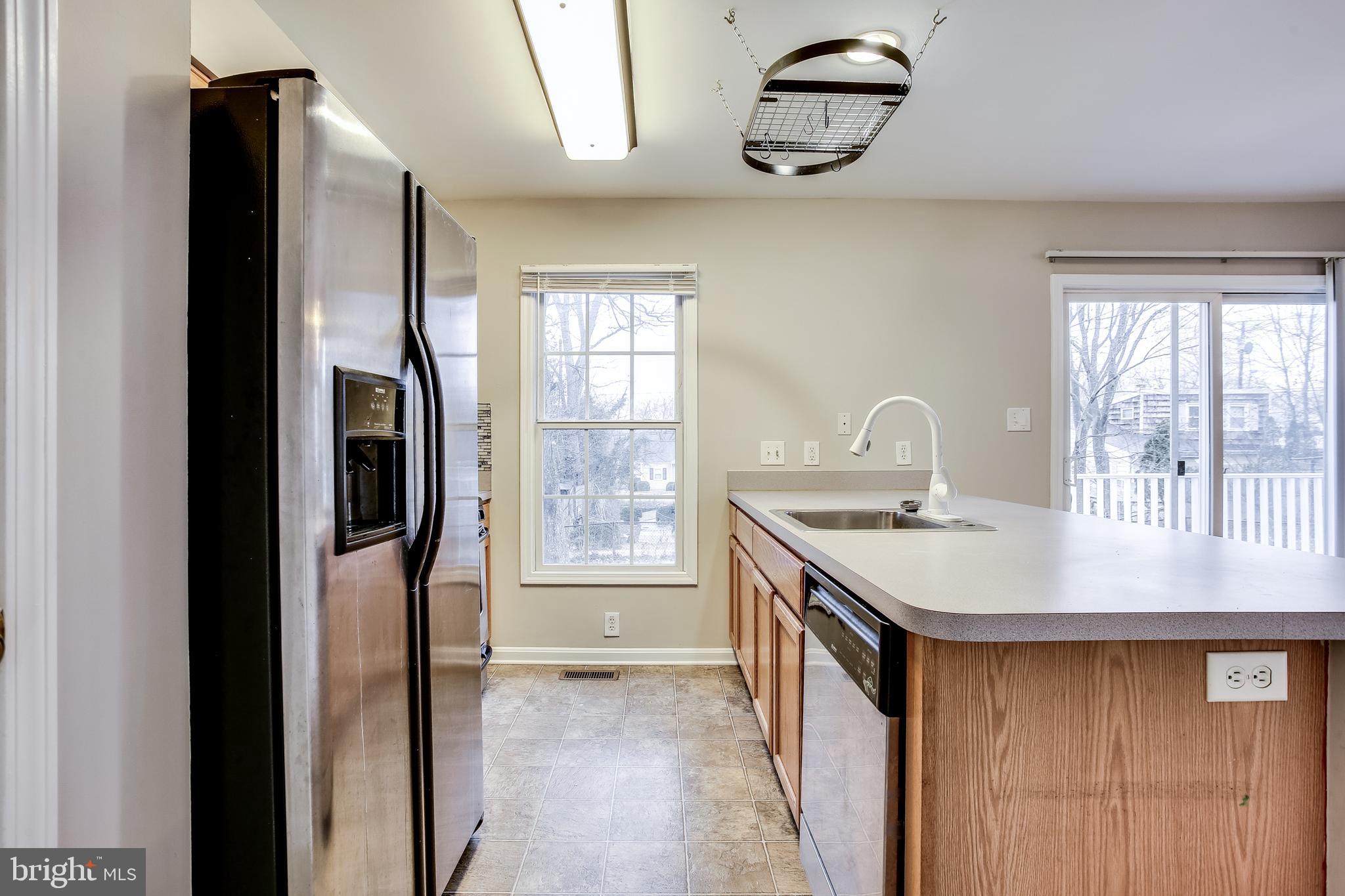 11506 Joseph Mill Road Silver Spring, MD 20906 - Photo 4 of 29 a kitchen with stainless steel appliances granite countertop a refrigerator a sink a stove and a window