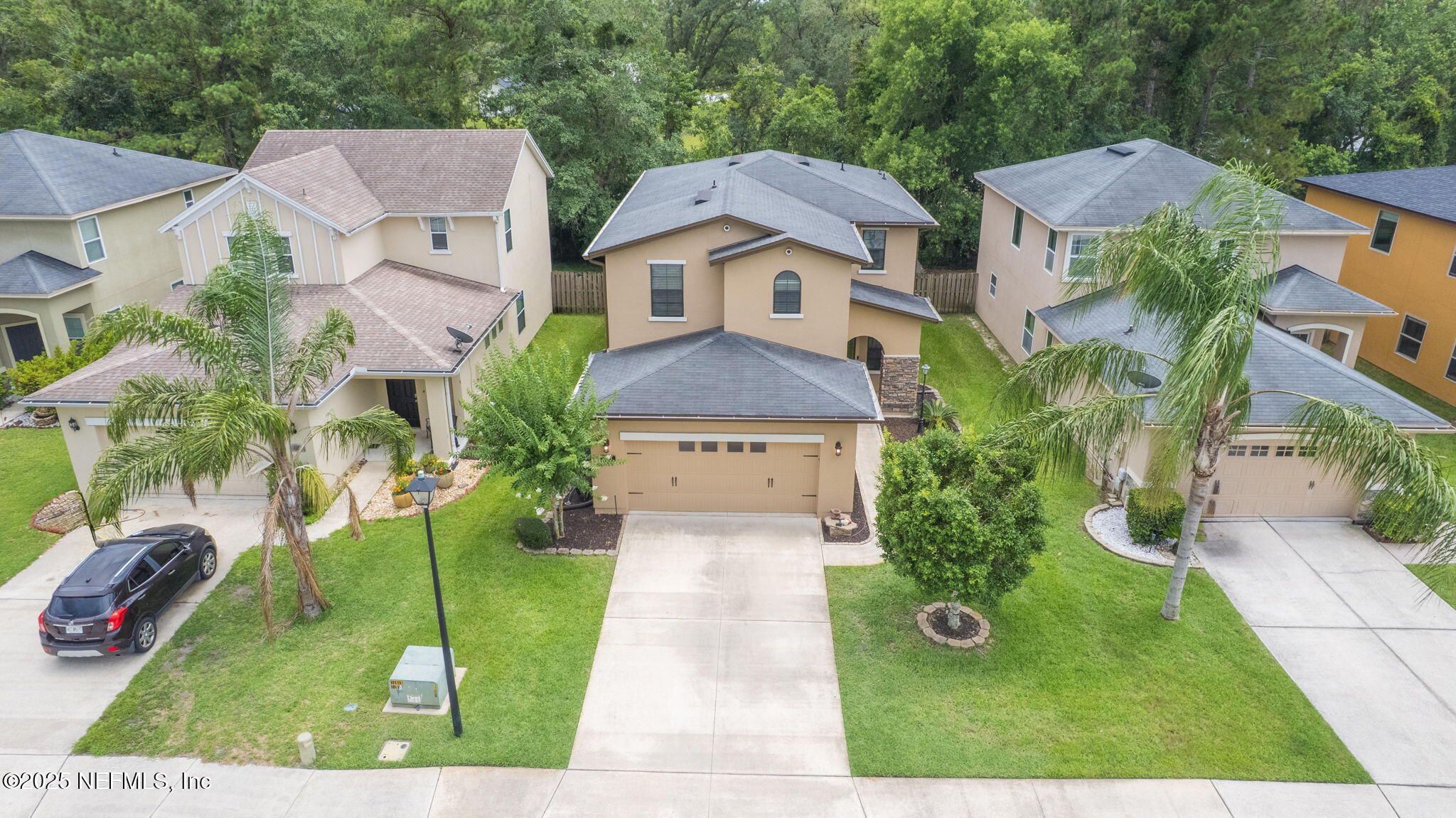 an aerial view of multiple houses with a yard