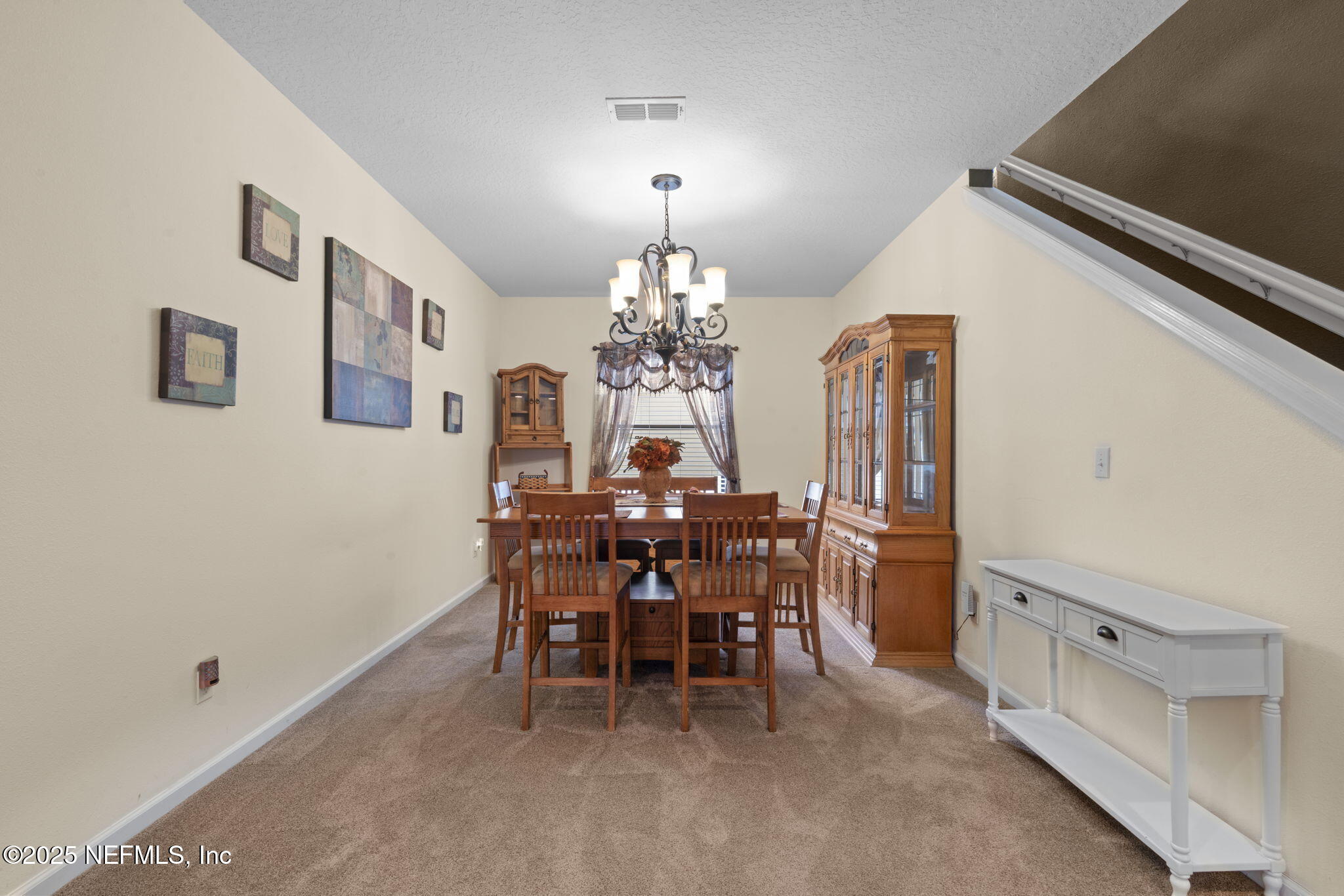 203 Buck Run Way St. Augustine, FL 32092 - Photo 12 of 62 a view of a dining room with furniture and chandelier