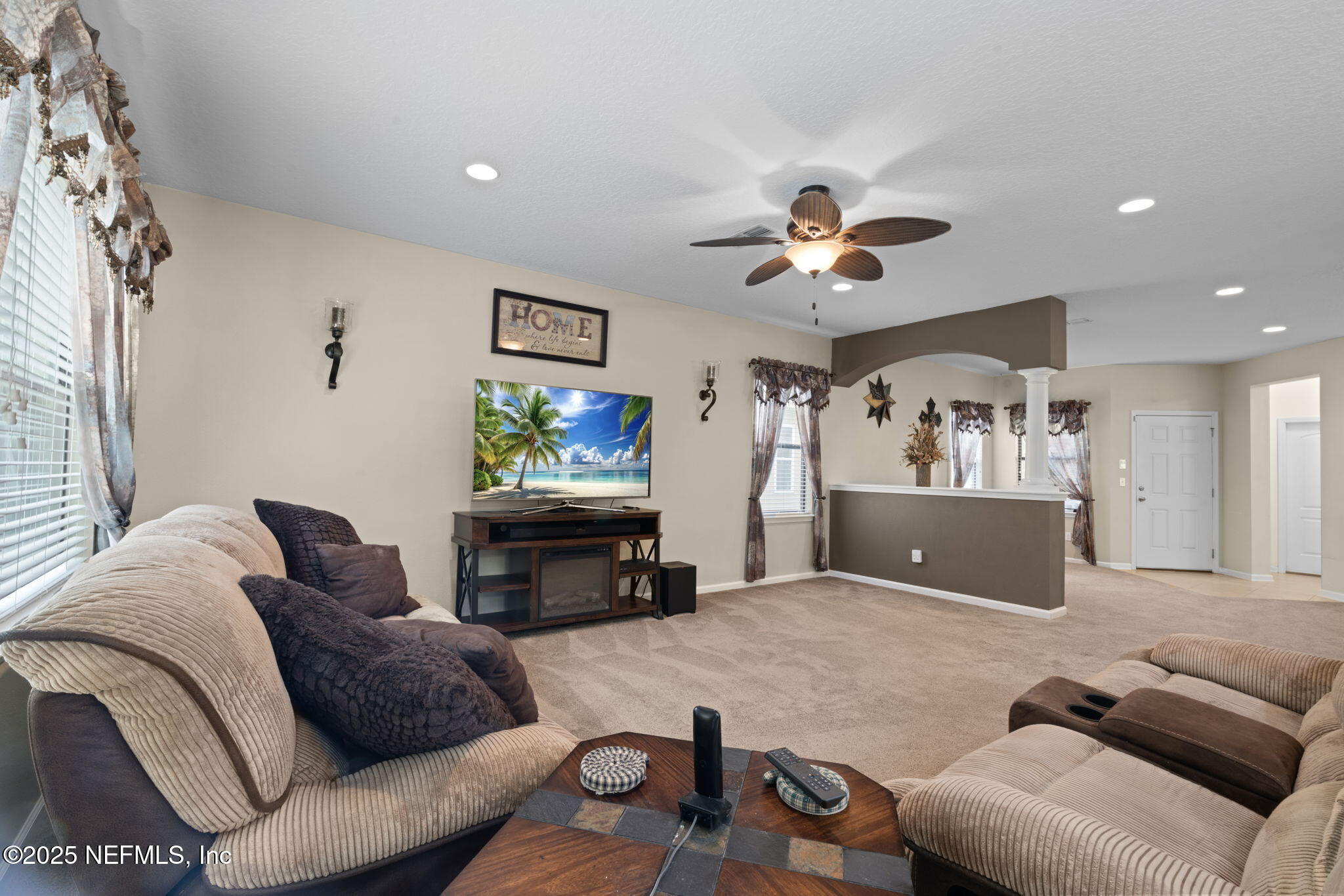 203 Buck Run Way St. Augustine, FL 32092 - Photo 18 of 62 a living room with furniture and a flat screen tv
