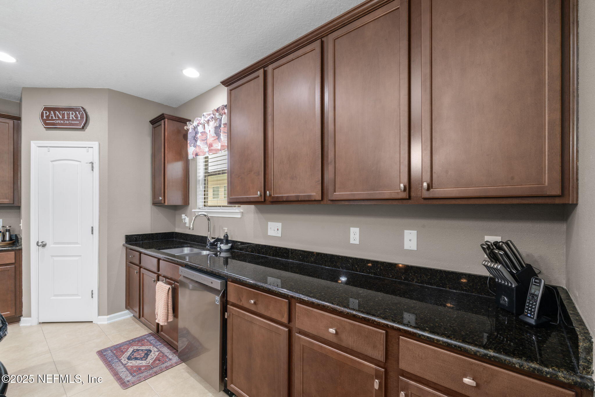 203 Buck Run Way St. Augustine, FL 32092 - Photo 21 of 62 a kitchen with granite countertop stainless steel appliances a sink and cabinets