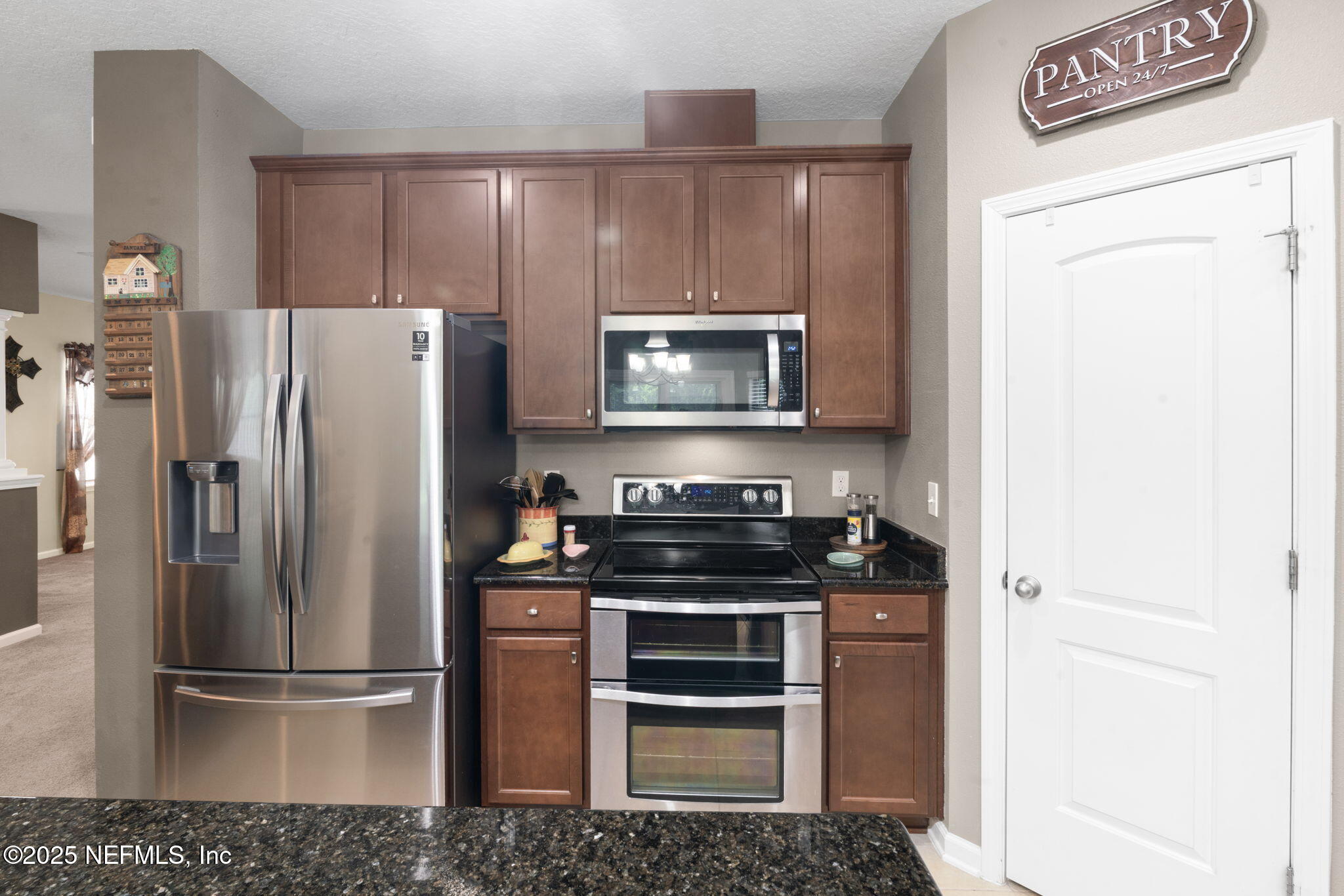 203 Buck Run Way St. Augustine, FL 32092 - Photo 23 of 62 a kitchen with a refrigerator stove and microwave