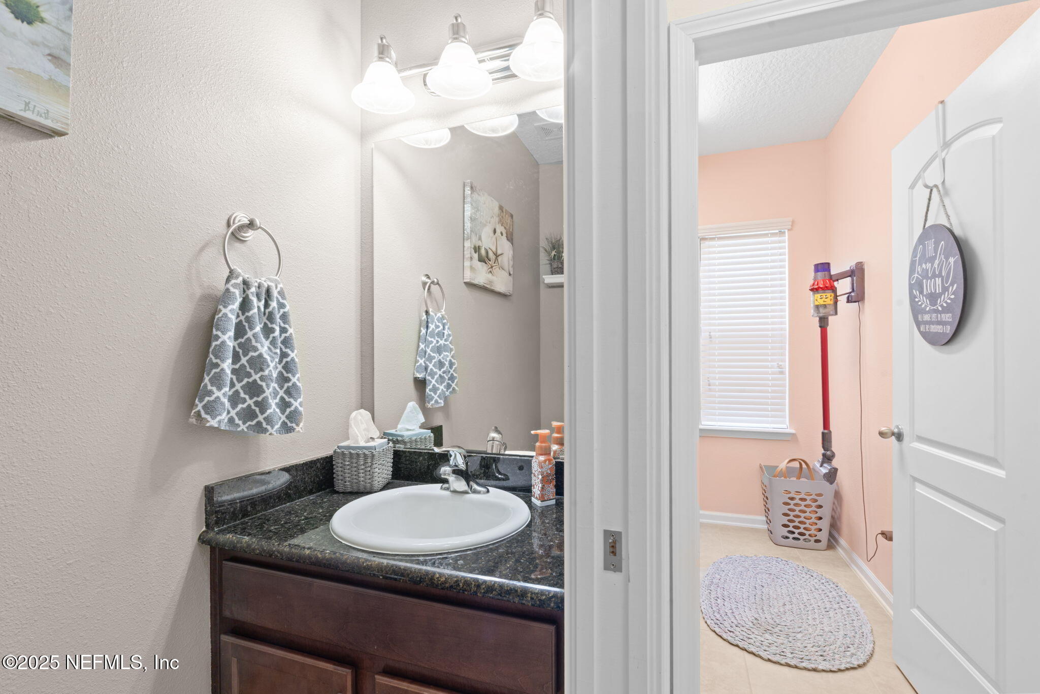 203 Buck Run Way St. Augustine, FL 32092 - Photo 26 of 62 a bathroom with a granite countertop sink a toilet and a mirror