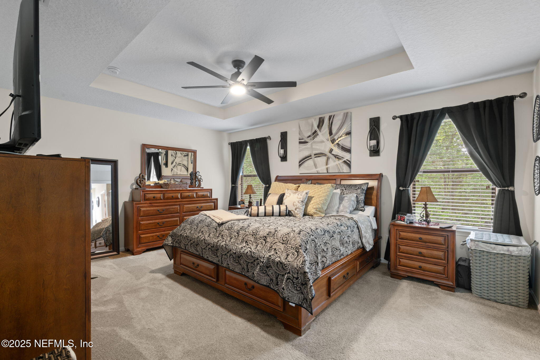 203 Buck Run Way St. Augustine, FL 32092 - Photo 28 of 62 a bedroom with a bed next to a window and a flat screen tv