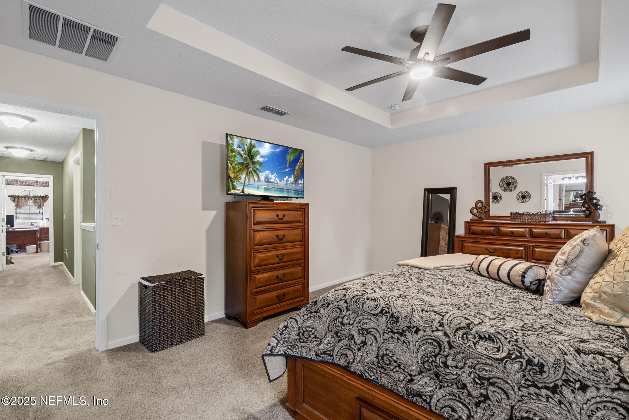 203 Buck Run Way St. Augustine, FL 32092 - Photo 30 of 62 a bedroom with a bed and a television