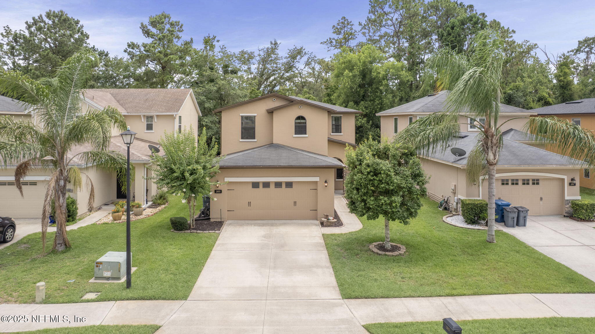 203 Buck Run Way St. Augustine, FL 32092 - Photo 3 of 62 a view of a white house with a yard plants and large tree