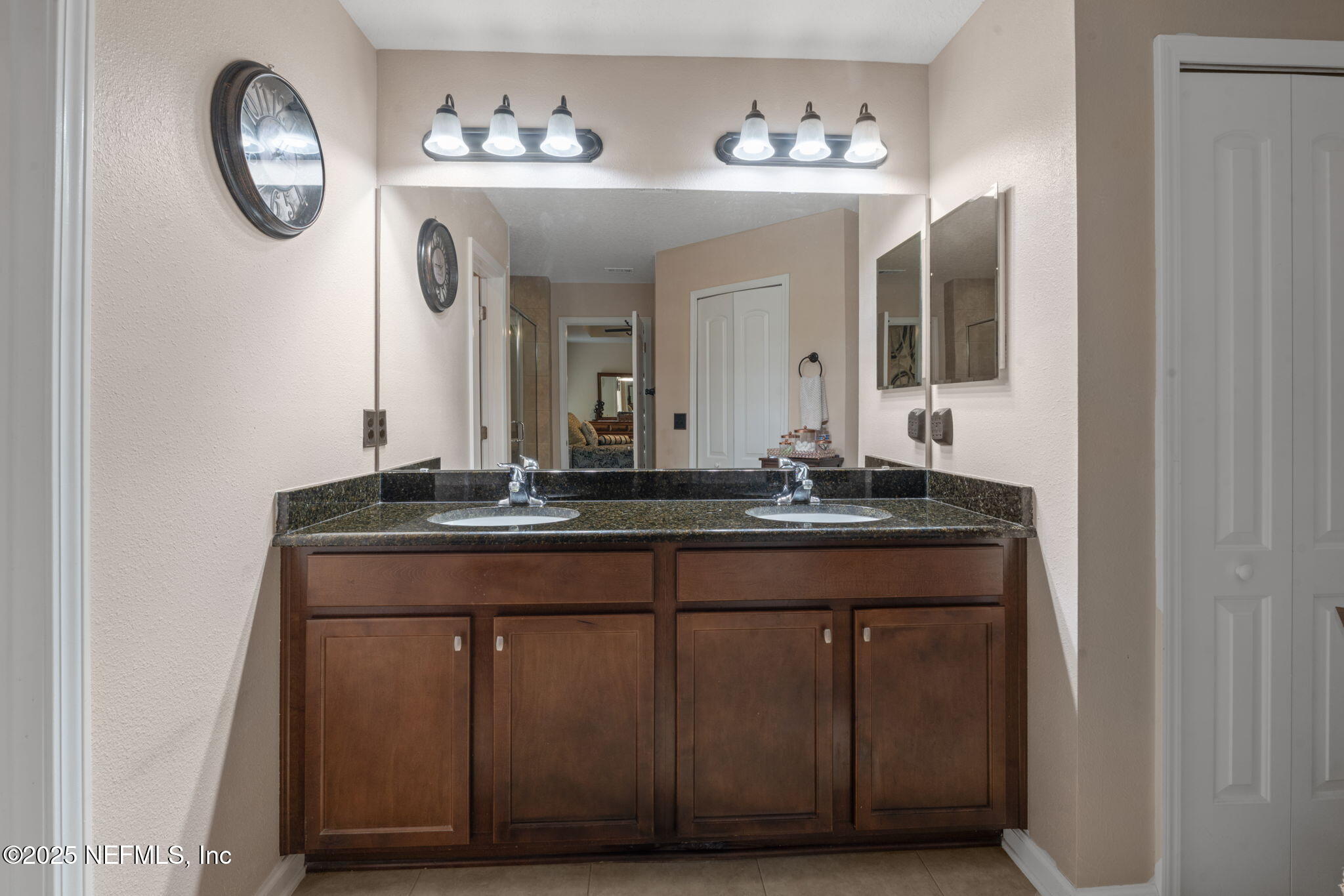 203 Buck Run Way St. Augustine, FL 32092 - Photo 31 of 62 a bathroom with a sink and a mirror
