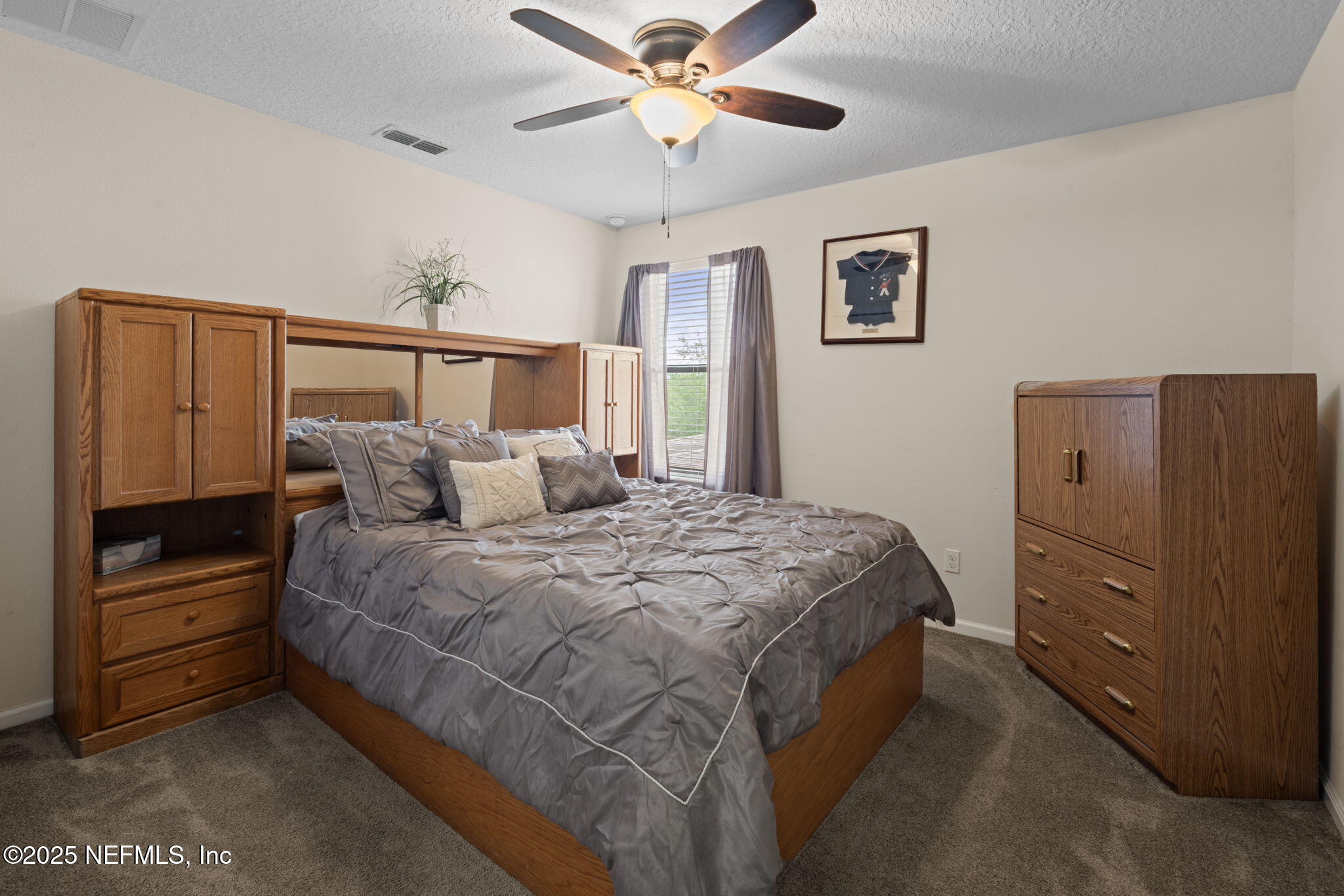 203 Buck Run Way St. Augustine, FL 32092 - Photo 34 of 62 a bedroom with a bed and a ceiling fan