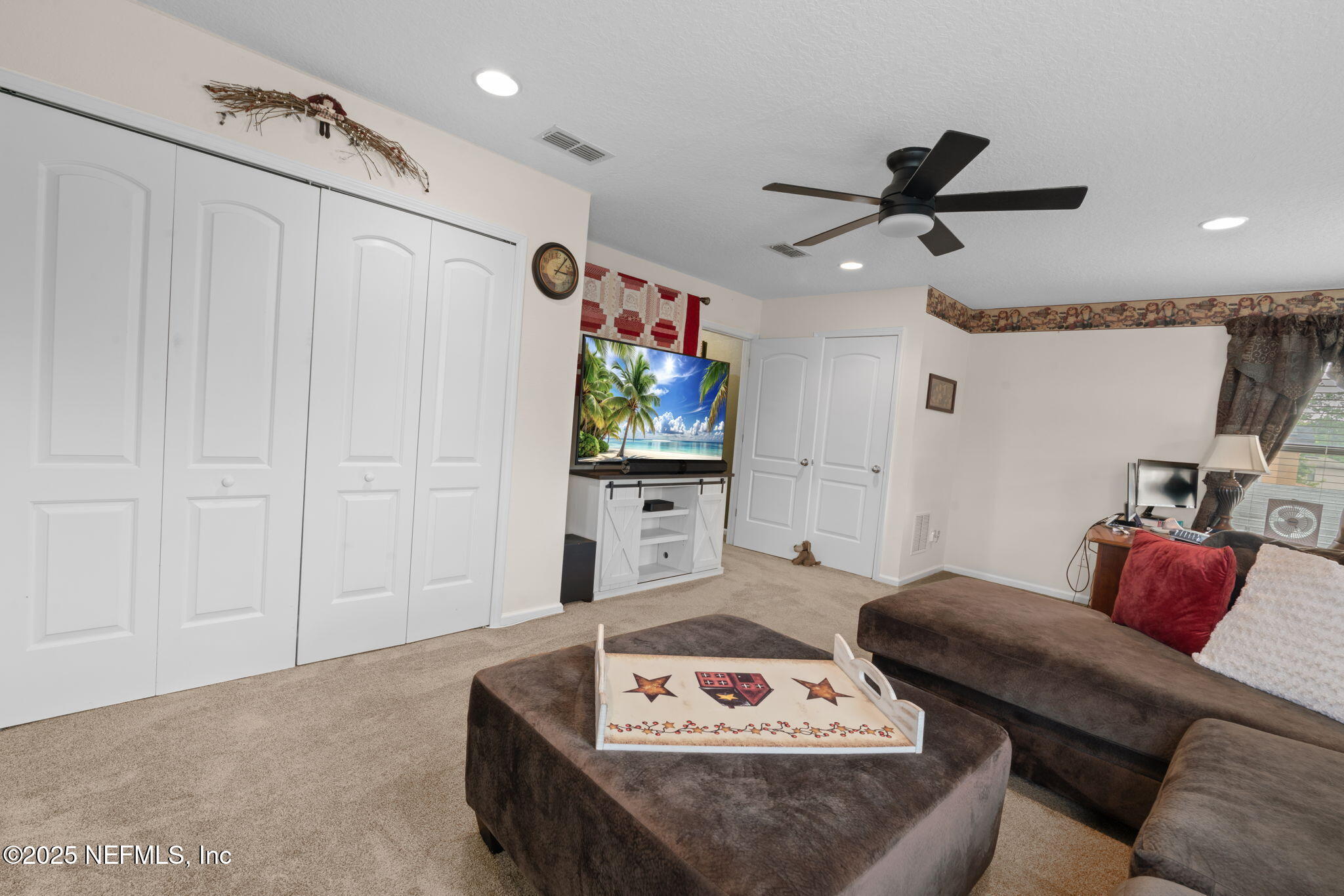 203 Buck Run Way St. Augustine, FL 32092 - Photo 39 of 62 a living room with furniture and a flat screen tv