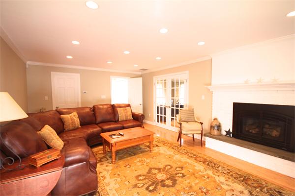 5 Gerald Road Marblehead, MA 01945 - Photo 9 of 16 a living room with furniture a fireplace and a flat screen tv