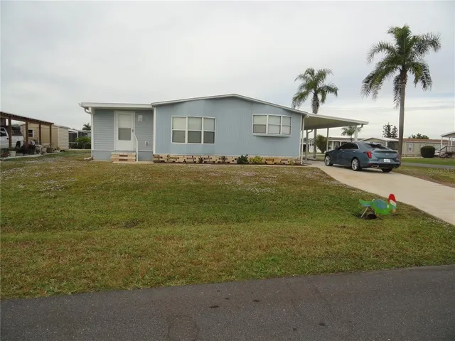 a view of a house with a yard and sitting area