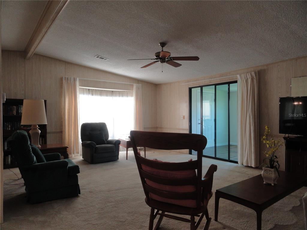 6233 Parakeet Road Englewood, FL 34224 - Photo 12 of 27 a living room with furniture and a flat screen tv