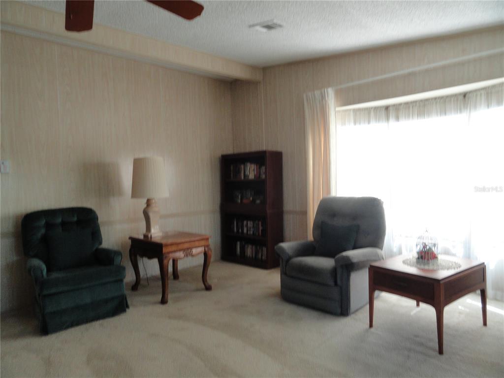 6233 Parakeet Road Englewood, FL 34224 - Photo 13 of 27 a living room with furniture and a window