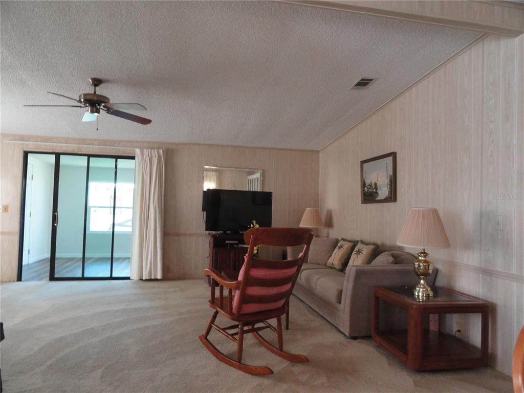 6233 Parakeet Road Englewood, FL 34224 - Photo 15 of 27 a living room with furniture and a flat screen tv