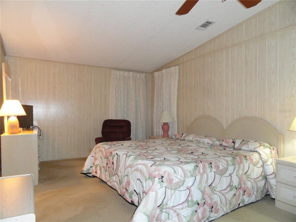 6233 Parakeet Road Englewood, FL 34224 - Photo 20 of 27 a bedroom with a bed and a cabinets