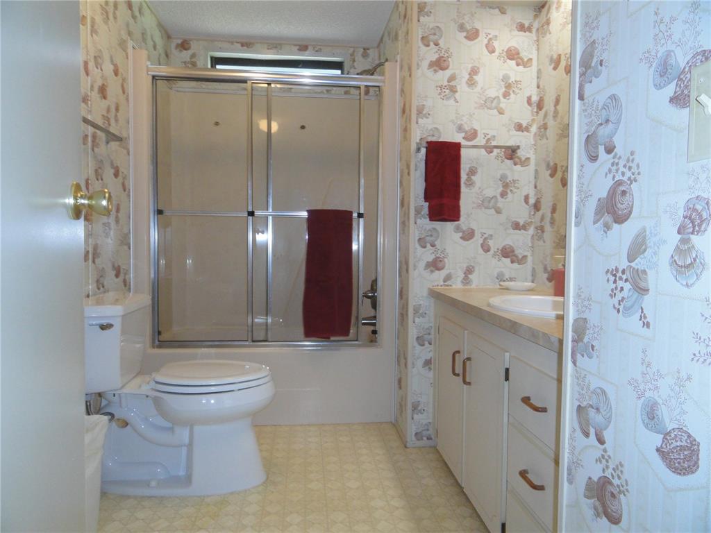 6233 Parakeet Road Englewood, FL 34224 - Photo 22 of 27 a bathroom with a sink and toilet