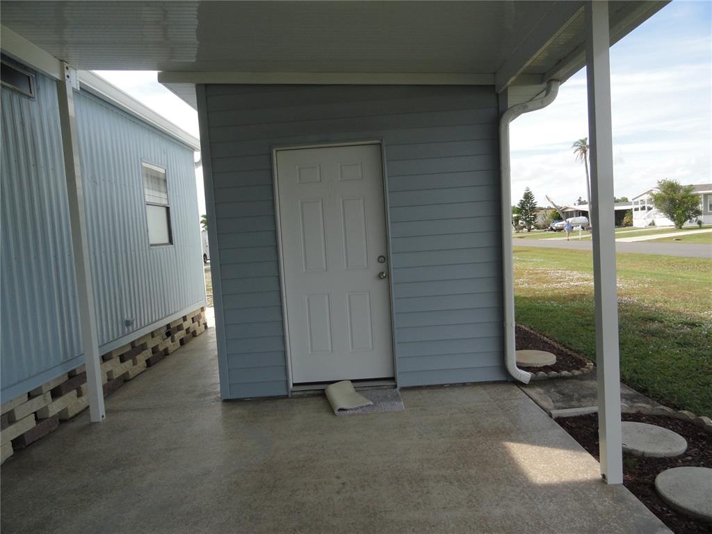 6233 Parakeet Road Englewood, FL 34224 - Photo 6 of 27 an empty room with sliding door and wooden floor