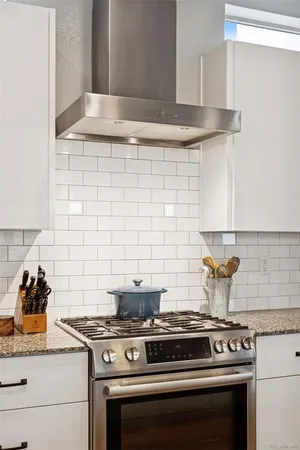 a stove top oven sitting inside of a kitchen