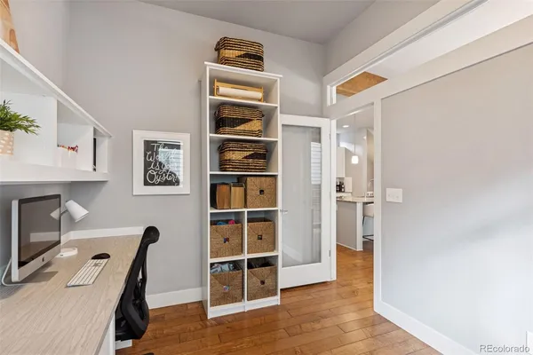 a view of a workspace with furniture and wooden floor