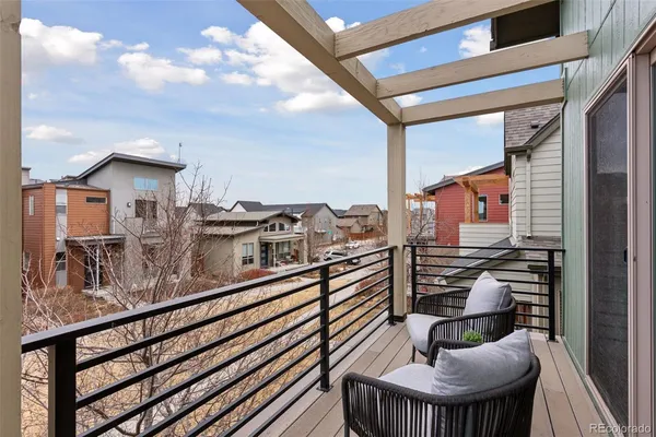 a balcony view with a seating space