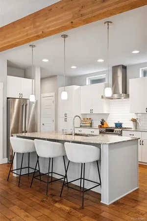 a kitchen with a table chairs stove and cabinets