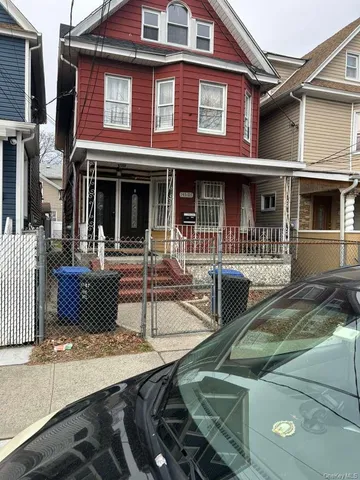 a view of a building with car parked