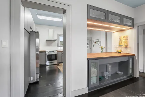 a open kitchen view with fireplace and wooden floor