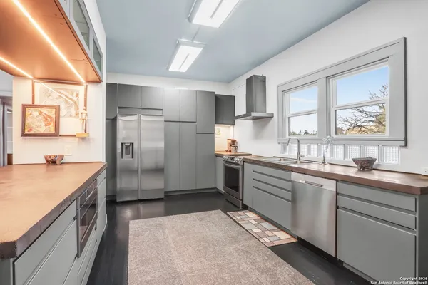 a kitchen with a sink stove and refrigerator