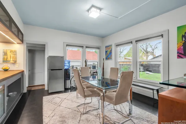 a dining room with furniture and a floor to ceiling window