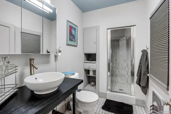 a bathroom with a sink toilet and shower
