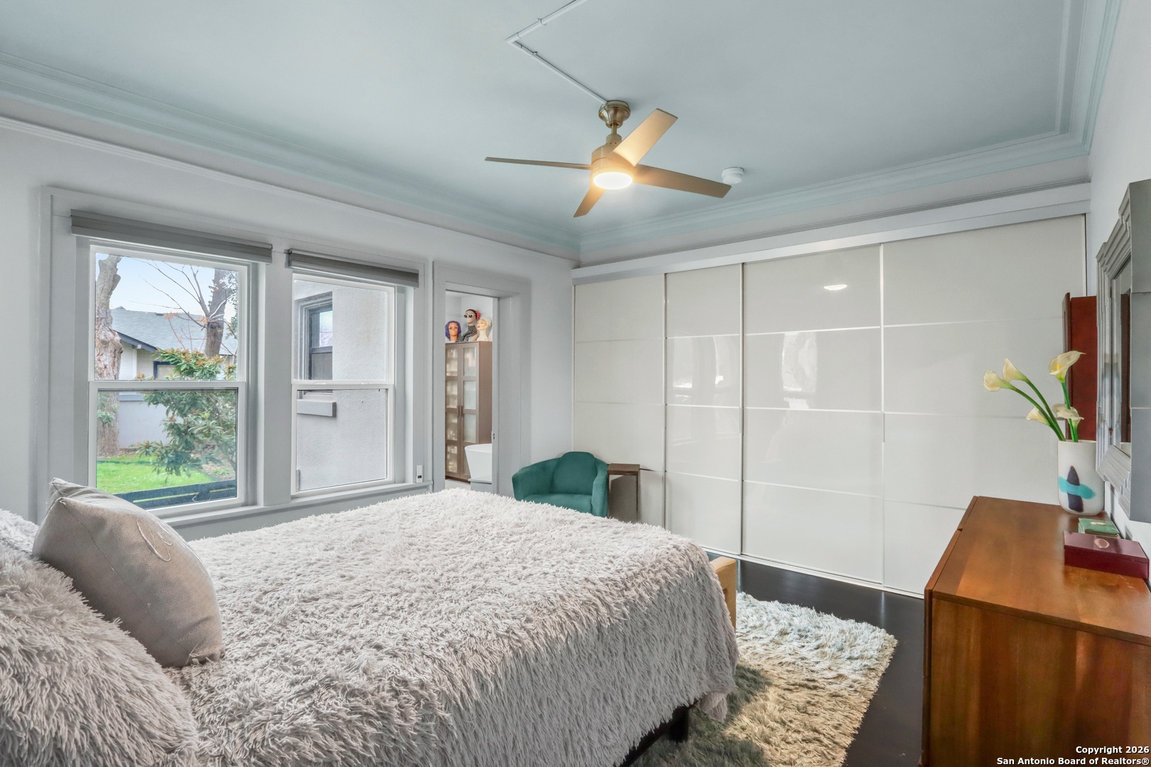 503 South Austin Street Seguin, TX 78155 - Photo 26 of 40 a bedroom with a bed a couch and a flat tv screen