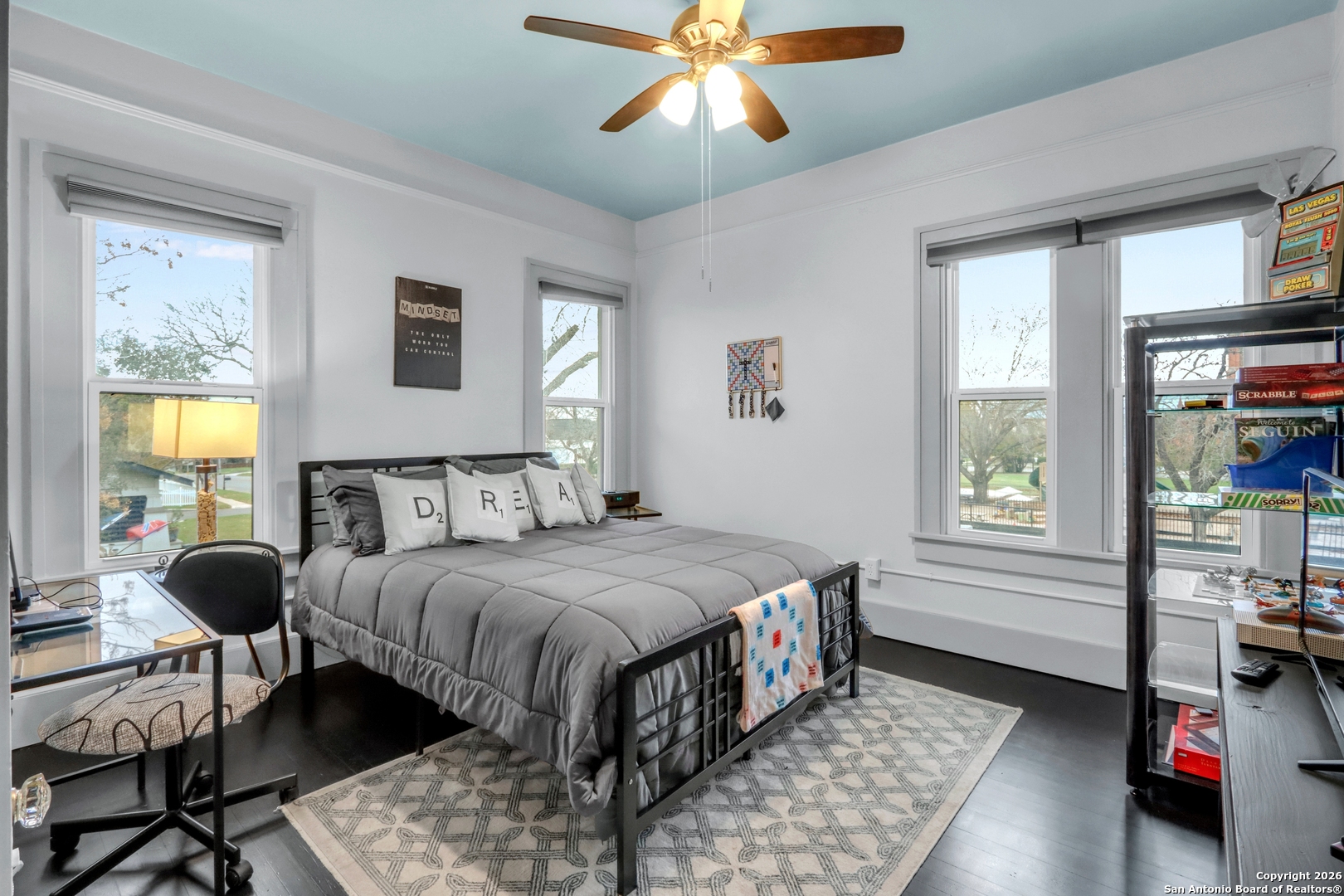 503 South Austin Street Seguin, TX 78155 - Photo 30 of 40 a bedroom with a bed a chandelier and a window