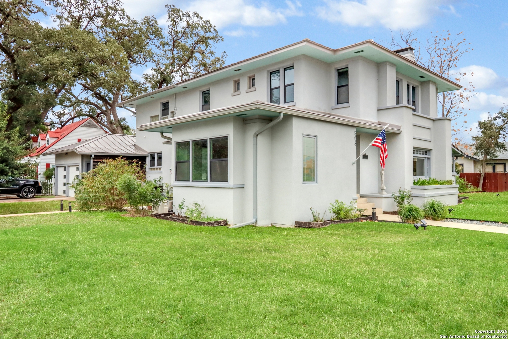 503 South Austin Street Seguin, TX 78155 - Photo 3 of 40 a view of white house with a big yard and large trees