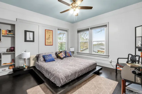 a work room with furniture a rug and white walls