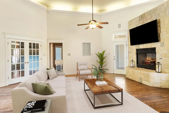 a living room with furniture a fireplace and a flat screen tv