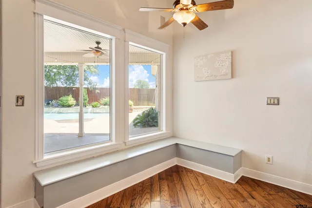 a view of a room with a window and wooden floor
