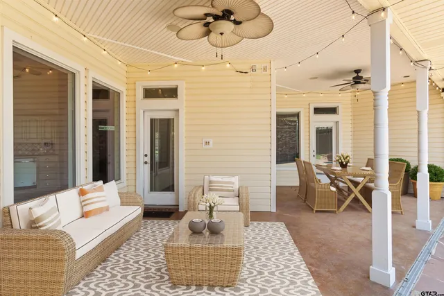a living room with furniture a rug and white walls