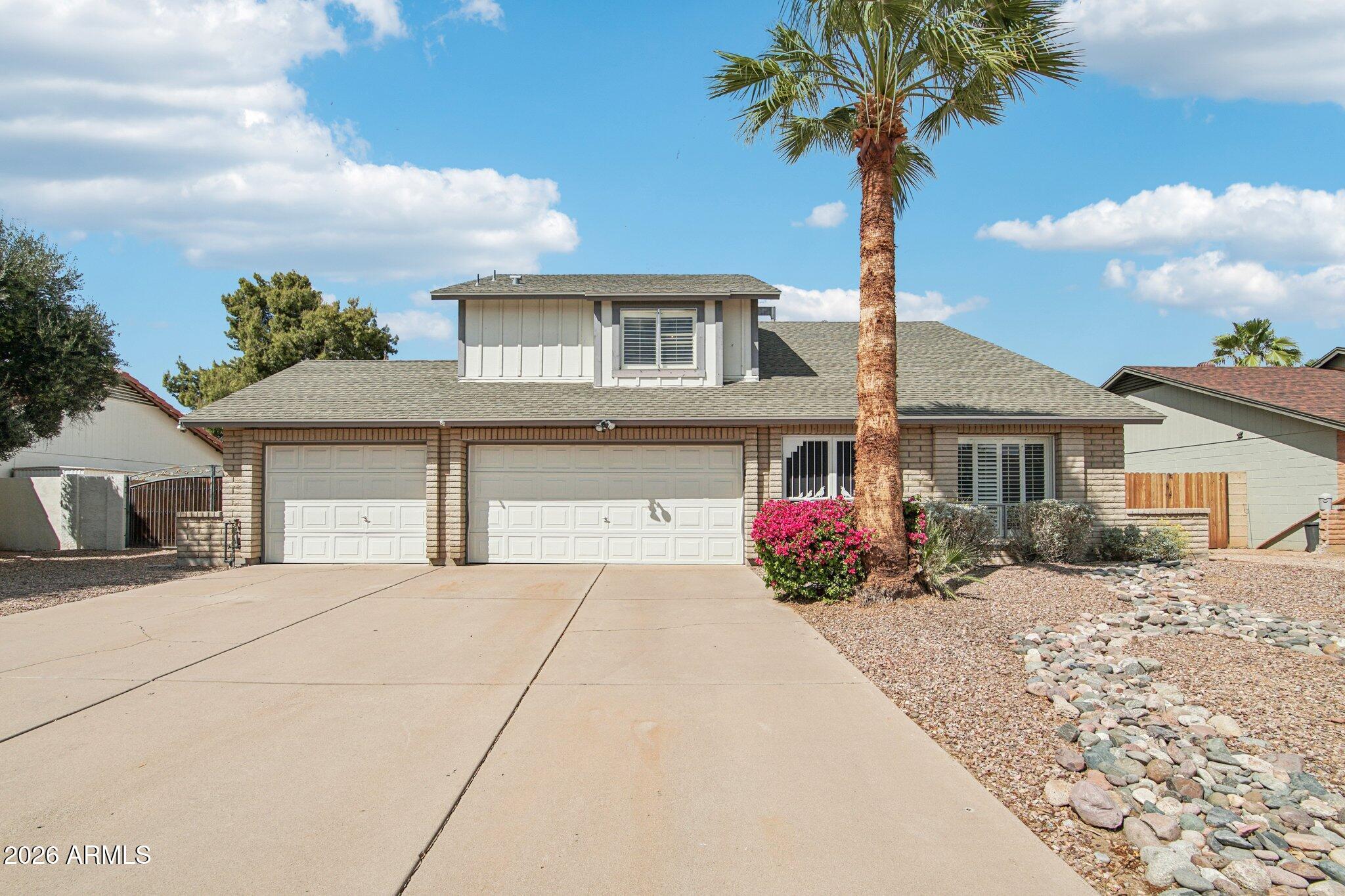 4662 East Grandview Road Phoenix, AZ 85032 - Photo 4 of 42 a front view of a house with yard and garage