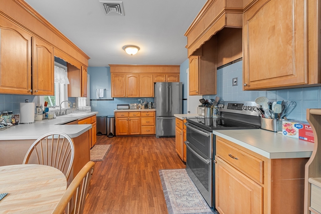 8 Mary Mt Road Auburndale, MA 02466 - Photo 14 of 36 a kitchen with stainless steel appliances granite countertop a stove a sink dishwasher and a refrigerator with wooden floor