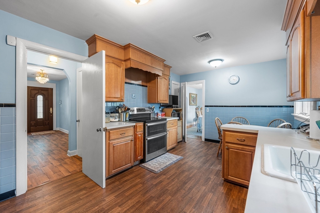 8 Mary Mt Road Auburndale, MA 02466 - Photo 16 of 36 a kitchen with stainless steel appliances granite countertop wooden cabinets and wooden floor