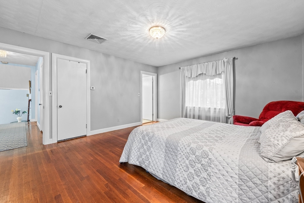 8 Mary Mt Road Auburndale, MA 02466 - Photo 22 of 36 a bedroom with a bed and a chandelier
