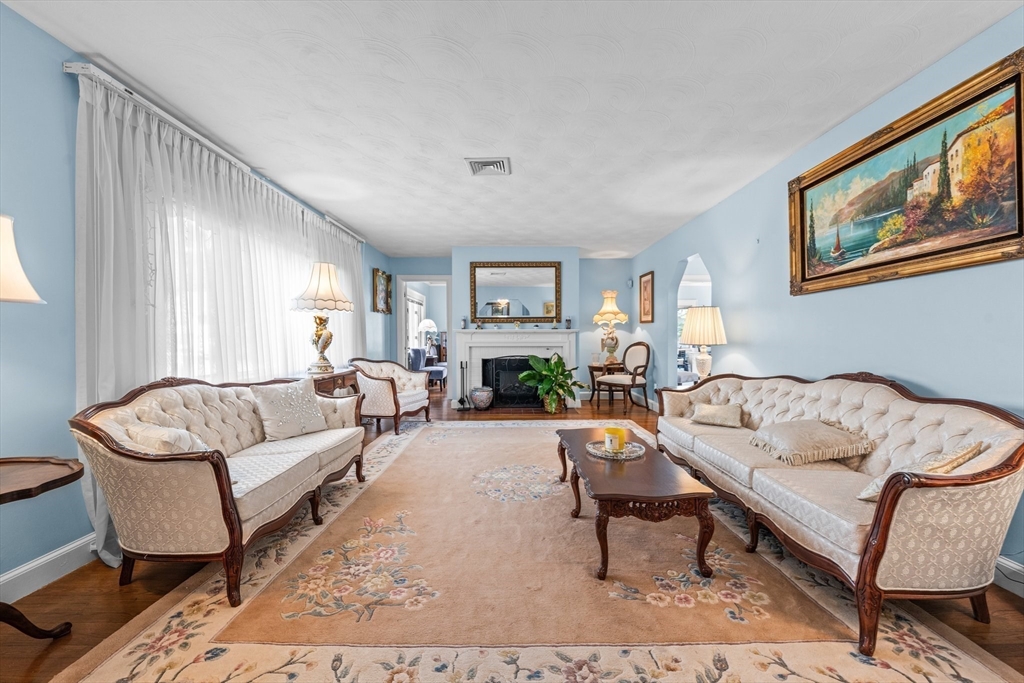 8 Mary Mt Road Auburndale, MA 02466 - Photo 8 of 36 a living room with furniture a flat screen tv and a fireplace