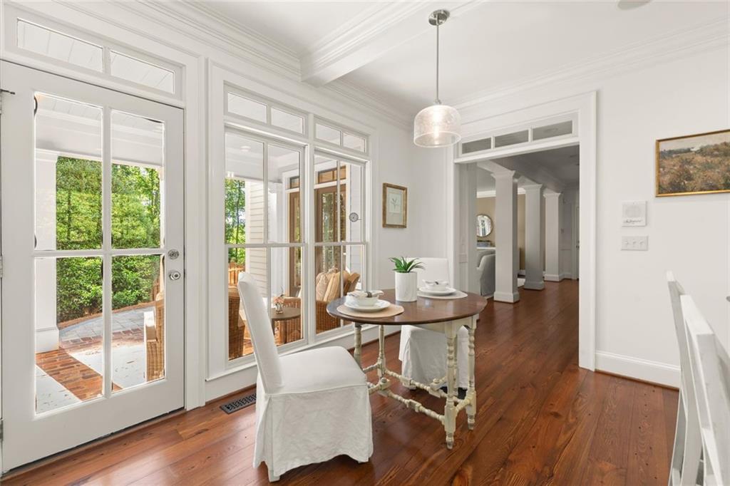 1450 Acworth Due West Road Northwest Kennesaw, GA 30152 - Photo 22 of 77 a dining room with wooden floor a chandelier a glass table and chairs