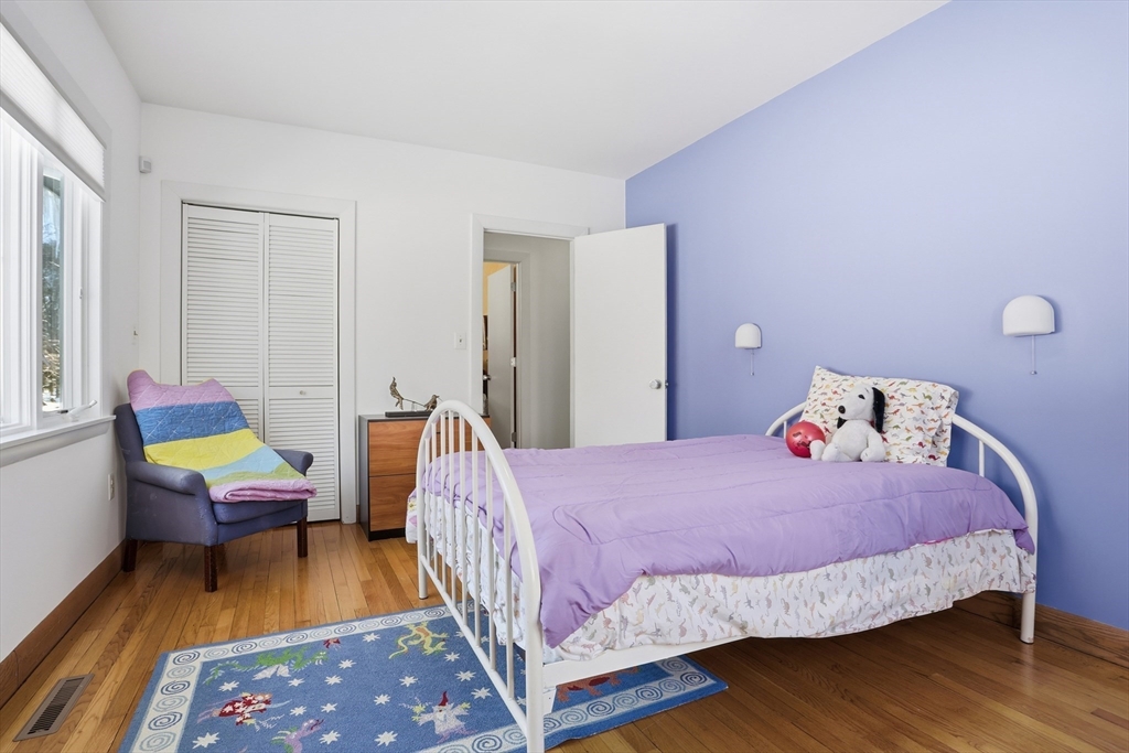 17 North Street Lexington, MA 02420 - Photo 23 of 42 a bedroom with a bed and a wooden floor