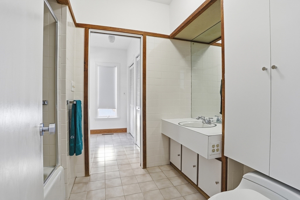 17 North Street Lexington, MA 02420 - Photo 24 of 42 a bathroom with a double vanity sink and a mirror