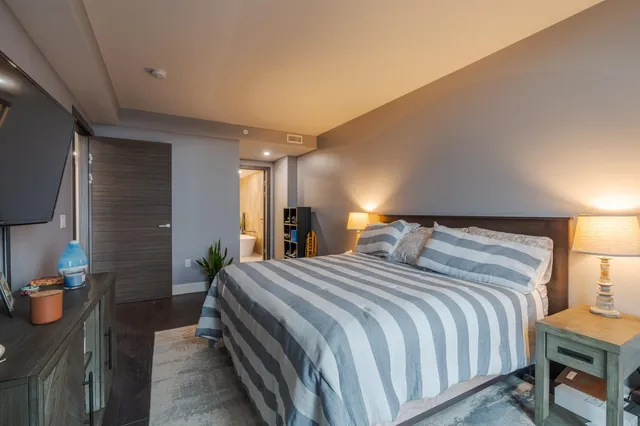 a bedroom with a bed and large mirror