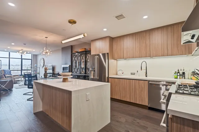 a kitchen with appliances a sink and cabinets