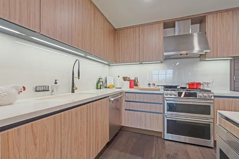 a large kitchen with a table and chairs