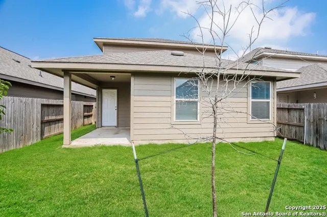a view of a house with a yard and front view of a house